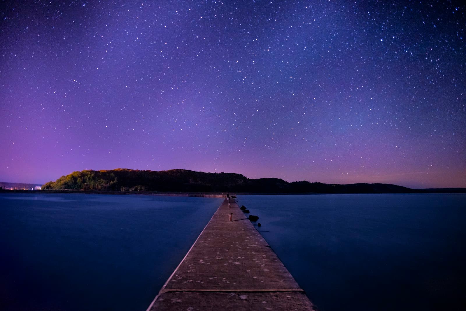 A calm night sky over still water — reflective guidance alongside counselling