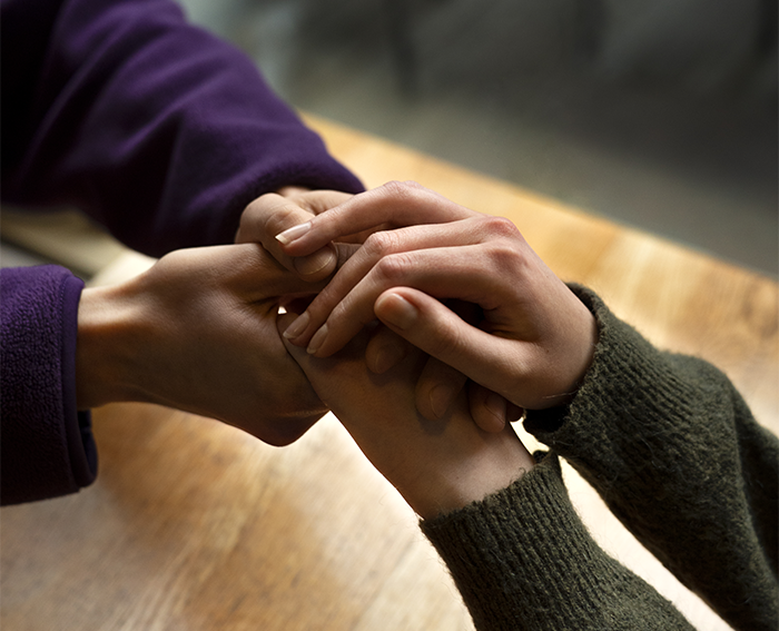 hands holding each other support